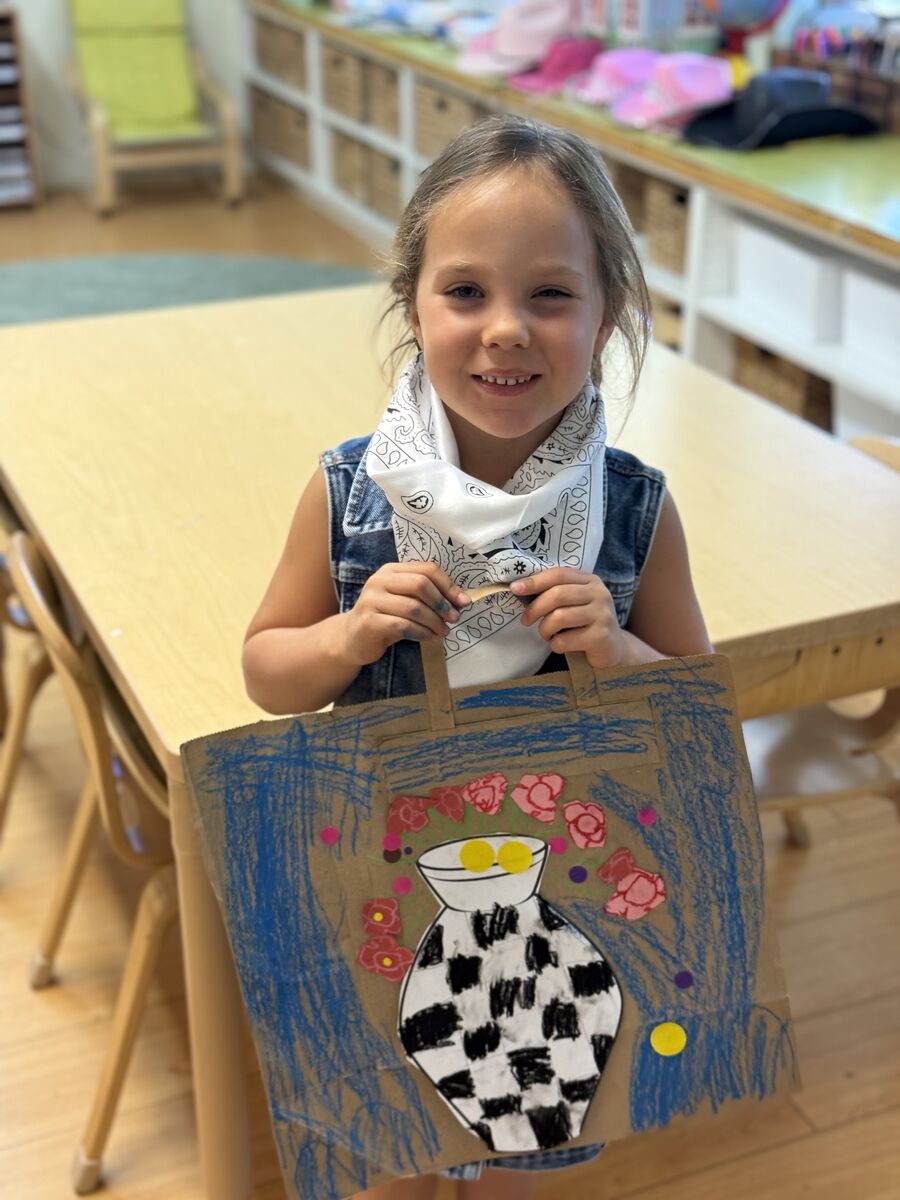 Student showing her artwork