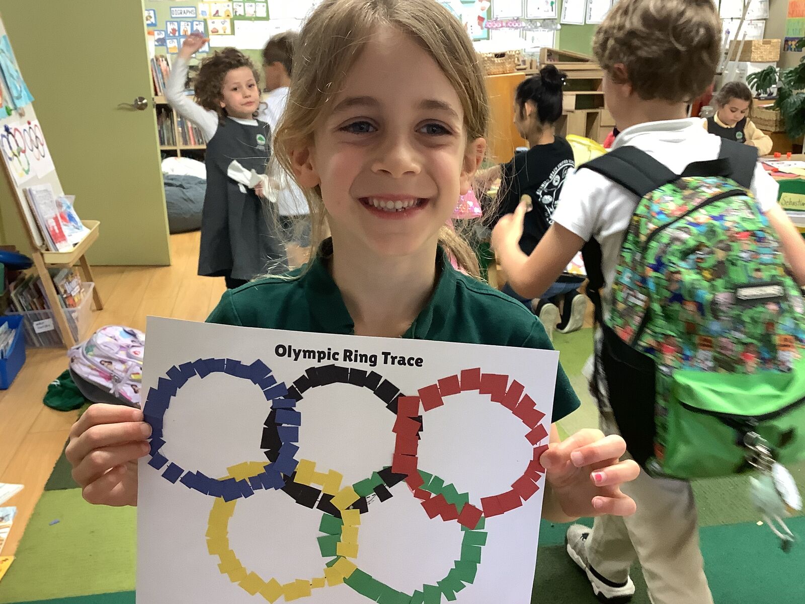 Student holding an Olympic ring trace project